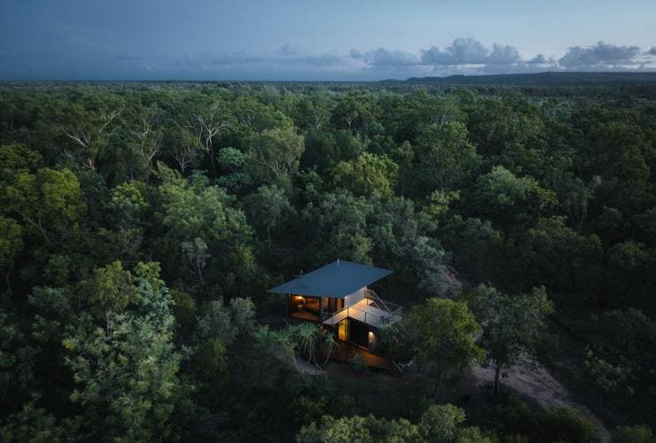 Aerial view over a building tucked within lush green bushland, Hideaway Litchfield, Northern Territory © Tourism NT/Jason Charles Hill 2021