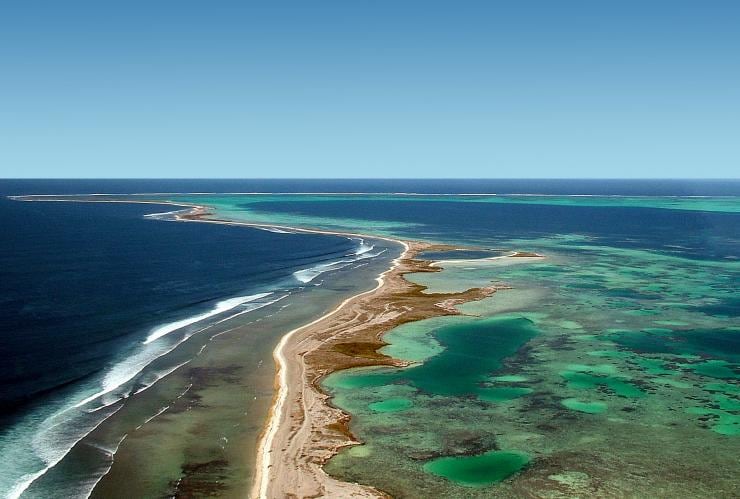 Aerial view over a long, thin island just above the ocean’s surface, Abrolhos Islands, Western Australia © Tourism Western Australia
