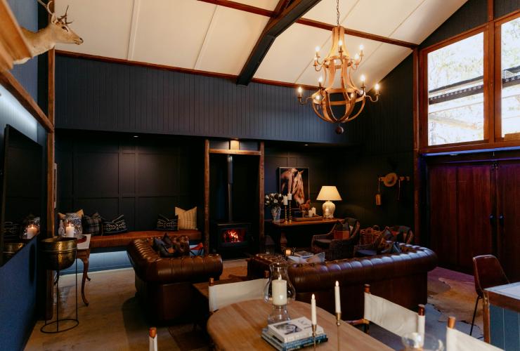 A lounge room with leather couches and a chandelier at Verandah House Country Estate, Tamborine Mountain, Queensland © Verandah House Country Estate