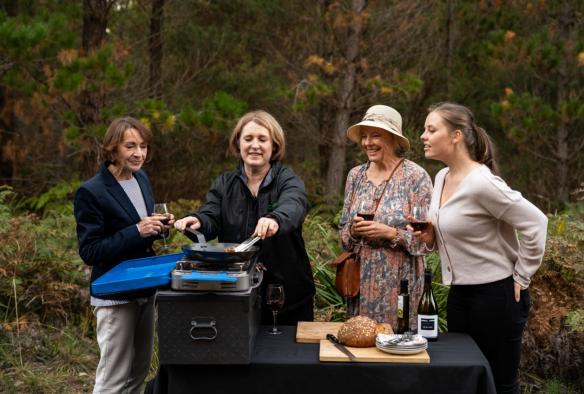 Women cooking outdoors on a tour with Experience Nature, Southern Highlands, New South Wales © Tourism Australia
