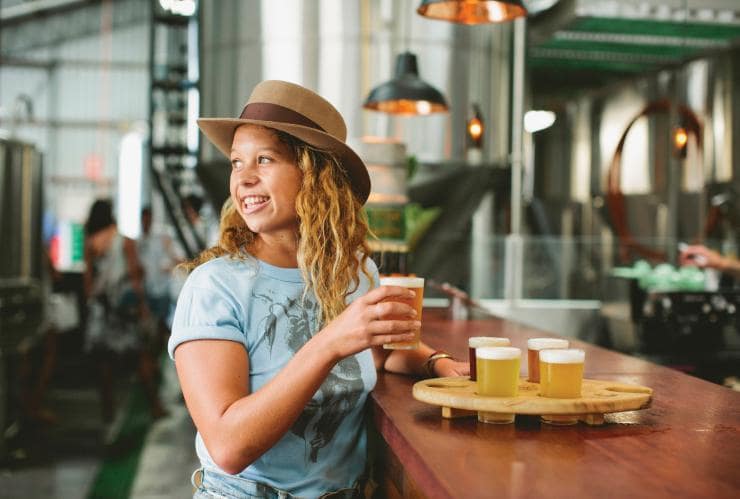 Woman tasting beer at Stone and Wood Brewing Company, Byron Bay, NSW © James Horan, Destination NSW
