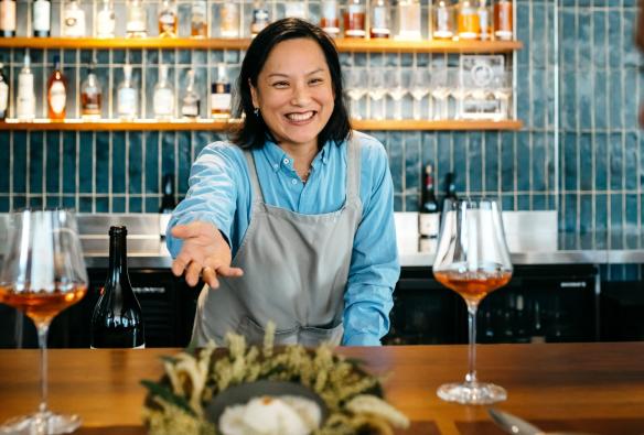 A restaurant staff member  presenting a dish over a counter, Pipit, Pottsville, New South Wales © Destination NSW 