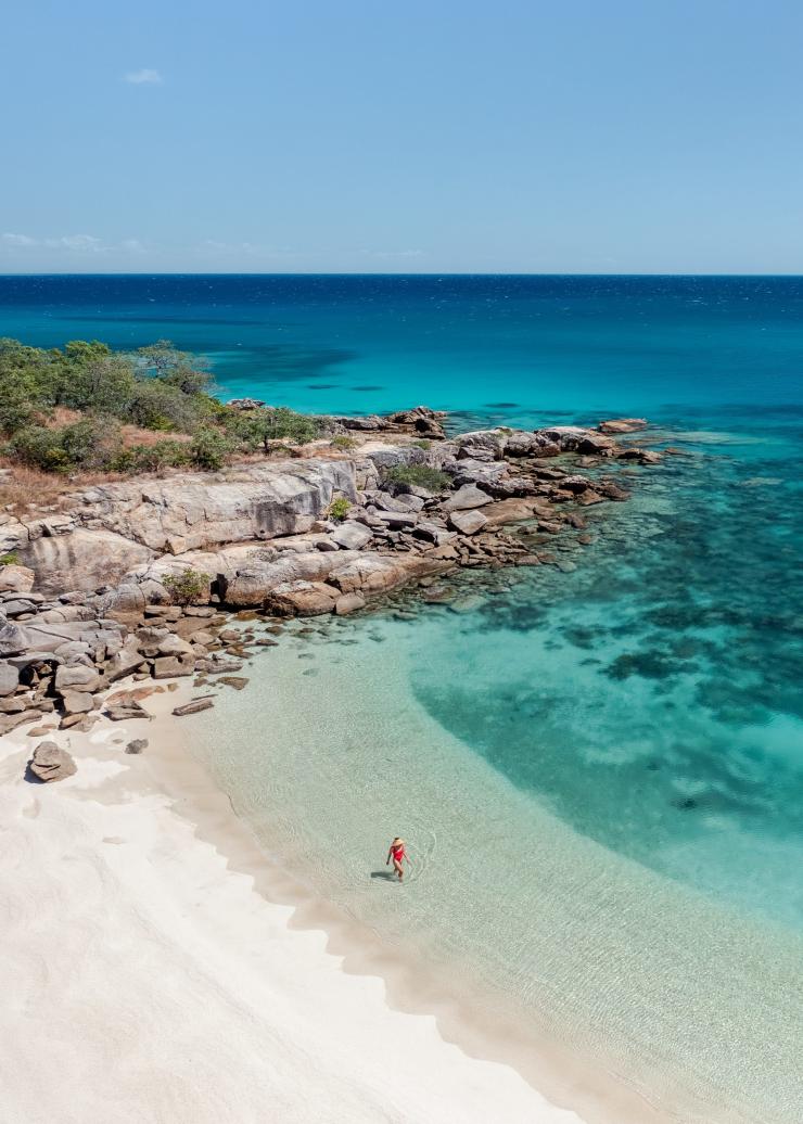 Aerial view over a person walking on a white sand beach, Lizard Island Resort, Lizard Island, Queensland © Tourism Australia
