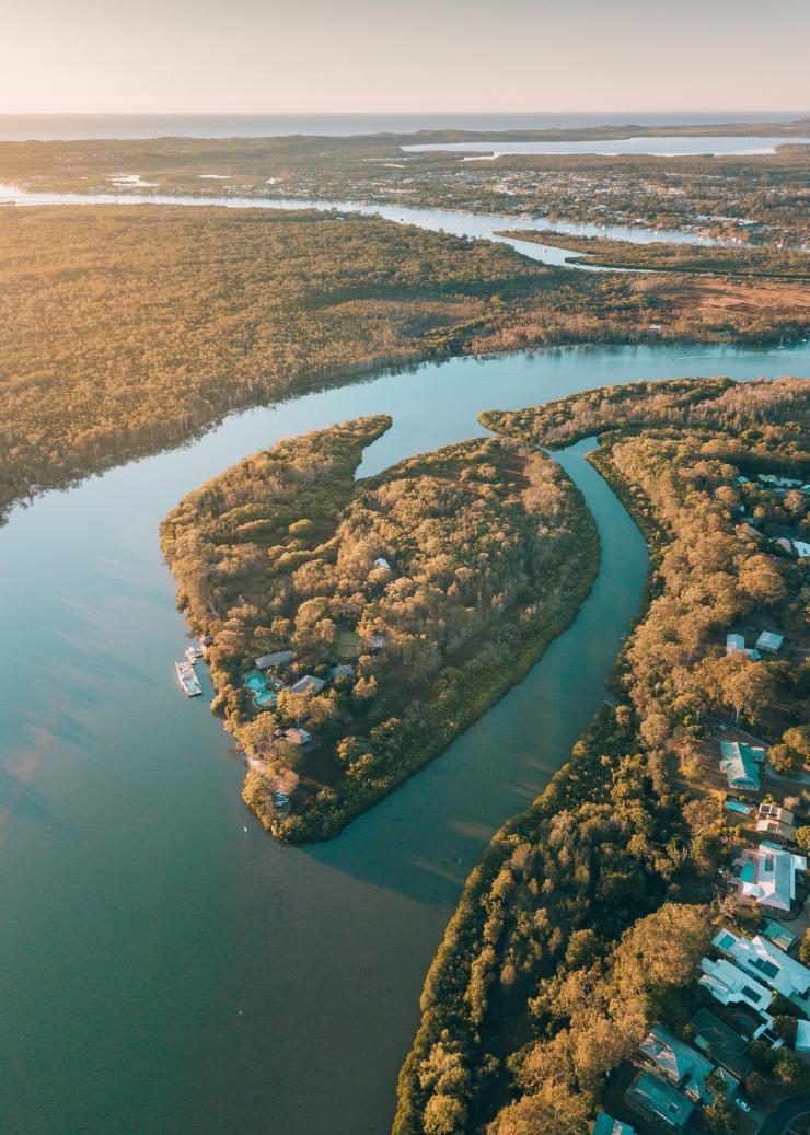 Aerial view over the greenery and waterways of Makepeace Island, Noosa, Queensland © Visit Noosa