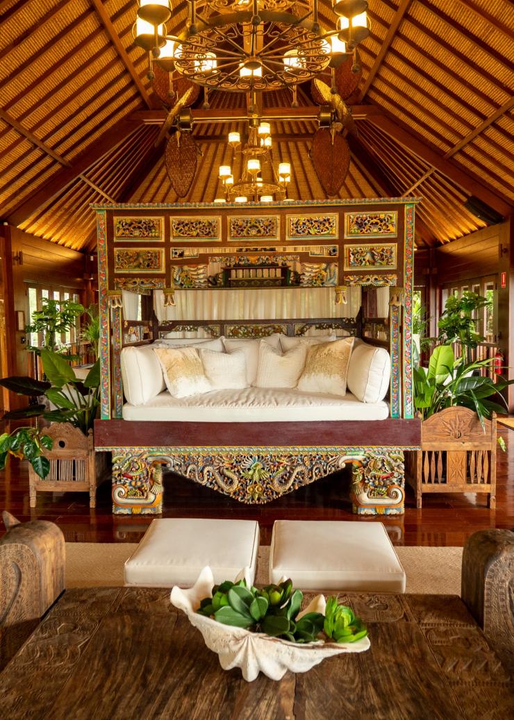 The interior of a wooden villa with ornate decor and a large day bed in the centre on Makepeace Island, Noosa, Queensland © Makepeace Island