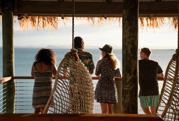 A group of people standing on a balcony overlooking the ocean on Pumpkin Island, Southern Great Barrier Reef, Queensland © Tourism and Events Queensland