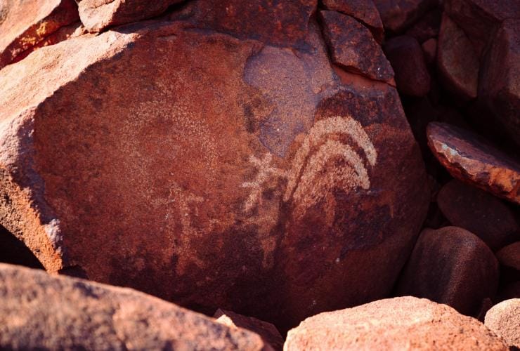 A red rock with ancient Aboriginal art, Murujuga Aboriginal Corporation, Pilbara, Western Australia © Tourism Western Australia