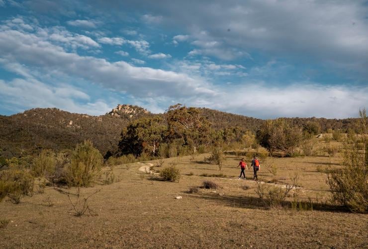 Two people hiking along a path through bushland, Tidbinbilla Nature Reserve, Paddys River, Australian Capital Territory © Rob Mulally