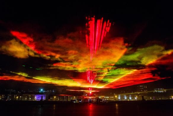 Red lights beaming from a city into the sky at night during Dark Mofo Festival, Hobart, Tasmania © Steve Tanner 