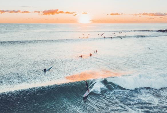 An aerial view of the surfers in the ocean at Currumbin Alley, Gold Coast, Queensland © Tourism Australia