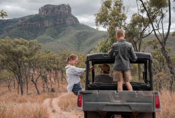 A family driving in a buggy surrounding by outback scenery at Mt Mulligan Lodge, Mt Mulligan, Queensland © Tourism and Events Queensland