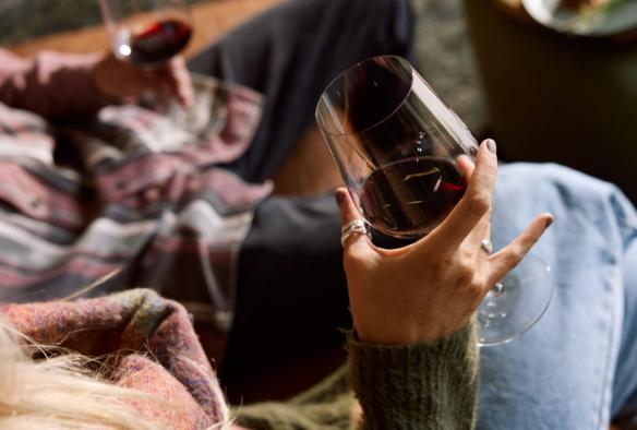 Couple drinking red wine by the fire, Parker Estate, Limestone Coast, South Australia © South Australian Tourism Commission
