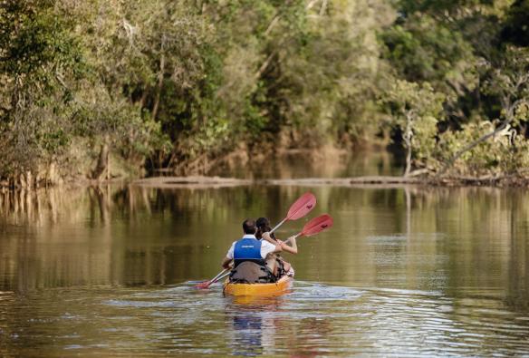 Canoeing down a calm river at Splitters Farm, Sharon, Queensland © Tourism Australia