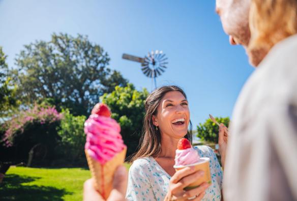 Woman smiling as she holds a pink ice cream at Tinaberries, Bundaberg, Queensland © Tourism and Events Queensland