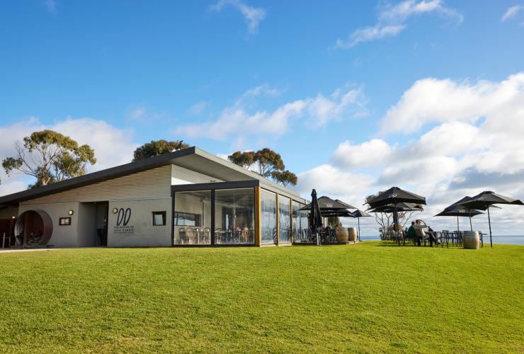 On a large patch of bright green grass, overlooking the bay in Bellarine, sits a smartly designed cellar door for Jack Rabbit winery, Geelong and the Bellarine, Victoria © Tourism Australia