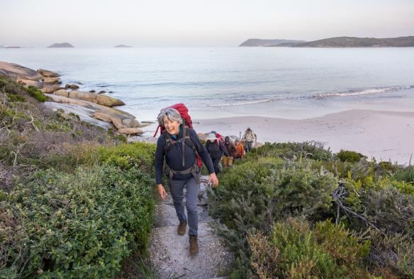 Group hiking on the beach in Albany, Western Australia © Susan McCabe t/as Busy Blue Bus Tours
