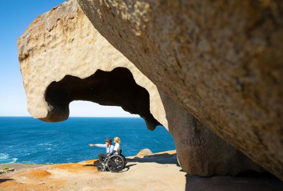 A woman using a wheelchair speaks with a local guide at the Remarkable Rocks, Kangaroo Island, South Australia © Tourism Australia