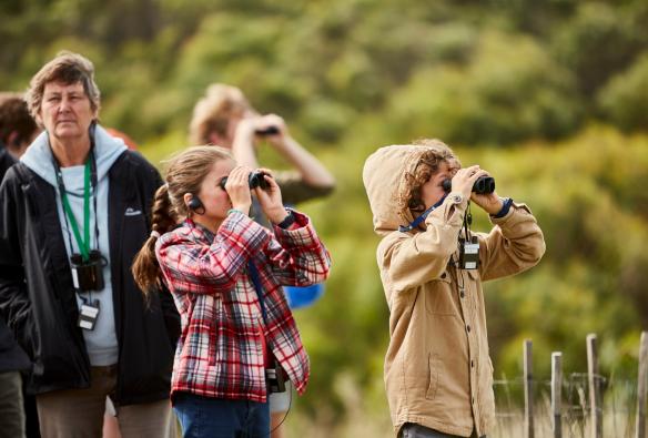 Children looking through binoculars during a Wildlife Wonders nature tour, Great Ocean Road, Victoria © Tourism Australia/Visit Victoria