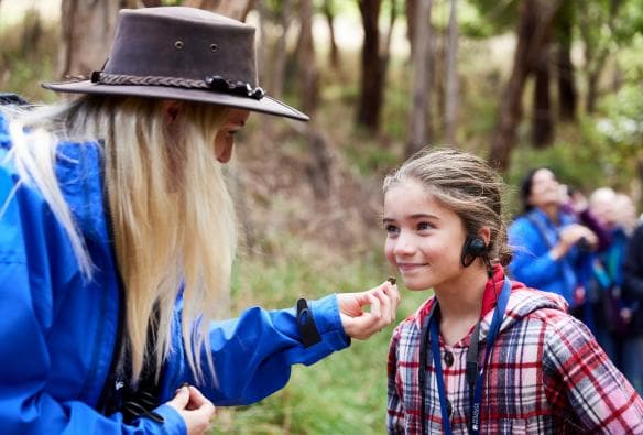 Child wearing a headset with a Wildlife Wonders tour guide, Great Ocean Road, Victoria © Tourism Australia/Wildlife Wonders