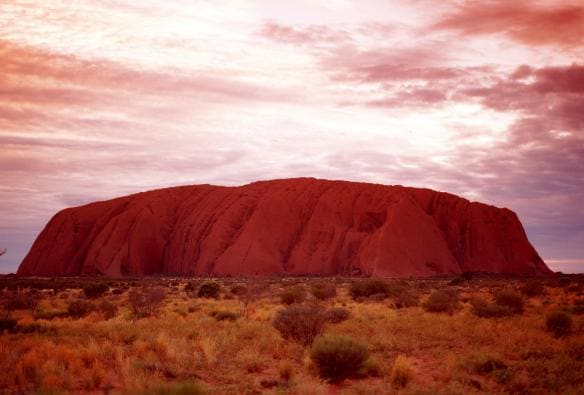 A sunset sky behind Uluru, Uluru-Kata Tjuta National Park, Northern Territory © Tourism Australia
