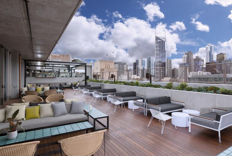 A rooftop bar lined with lounges and seating at QT Melbourne, Melbourne, Victoria © LANEWAY Photography