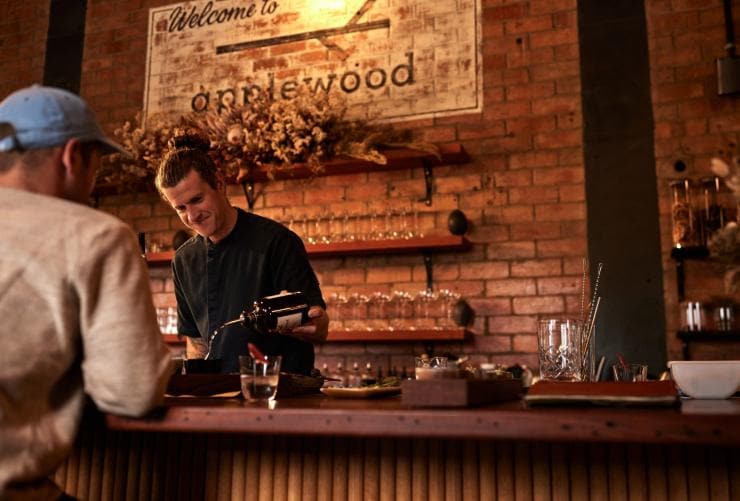 Bartender pouring a drink at Applewood Distillery, Adelaide Hills,South Australia © South Australian Tourism Commission