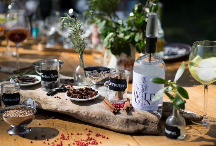 A table displaying wild gin and ingredients such as cinnamon and coriander at Kangaroo Island Spirits Distillery, Kangaroo Island, South Australia © Adam Bruzzone