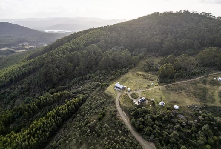 Aerial view of McHenry Distillery which sits on top of a hill surrounded by trees in the Tasman Peninsula, Tasmania © Tourism Australia