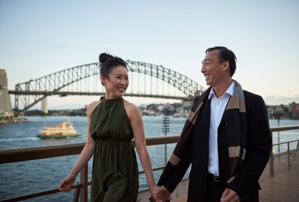 Couple dressed up for dinner while enjoying harbour views, Bennelong, Sydney Harbour, New South Wales © Destination NSW