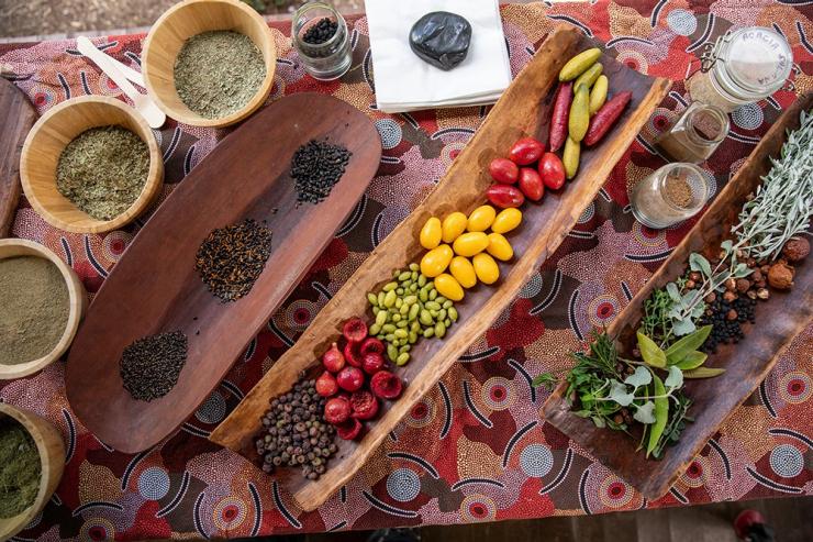 A table adorned with fresh native fruits, grains and plants including salt bush, Dale Tilbrook Bush Tucker Experience, Caversham, Perth, Western Australia © Tourism Australia