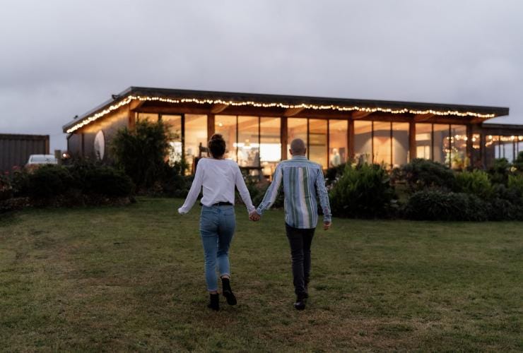 A couple walking toward Gurney's Cidery, Gippsland, Victoria © Tourism Australia