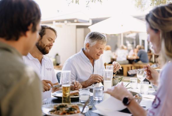 Group enjoying an al fresco meal at Olio Bello, Margaret River, Western Australia © Tourism Australia 