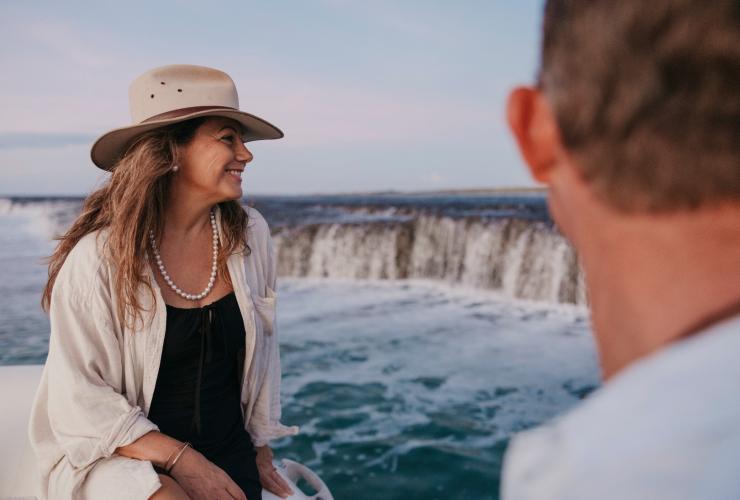A woman wearing a pearl necklace on a boat near a waterfall at Cygnet Bay Pearl Farm, Dampier Peninsula, Western Australia © Tourism Western Australia