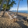 A long table on a white sand beach surrounded by palm trees, Nu Nu Restaurant, Palm Cove, Queensland © Tourism Tropical North Queensland 
