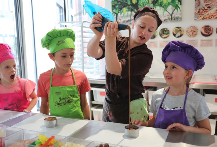 Kids enjoying a chocolate making workshop while wearing colourful chef’s hats, Great Ocean Road Chocolaterie & Ice Creamery, Bellbrae, Victoria © Great Ocean Road Chocolaterie & Ice Creamery 