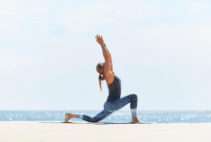 Woman doing a yoga pose by the beach at Injidup Spa Retreat in Margaret River, WA © Injidup Spa Retreat