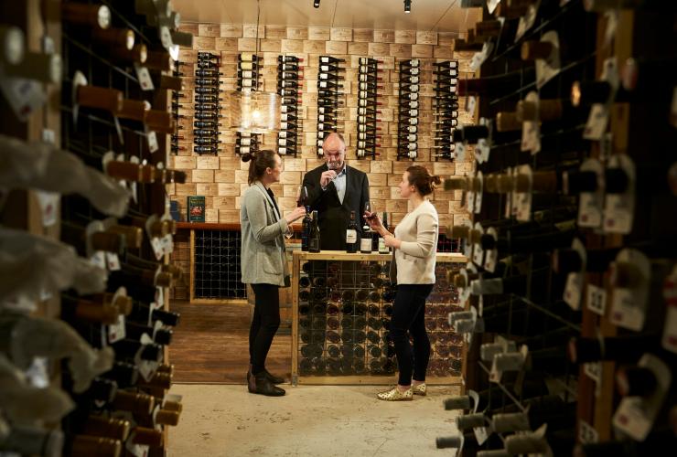 Three people tasting wine in a cellar door, Royal Mail Hotel, Grampians, Victoria © Visit Victoria