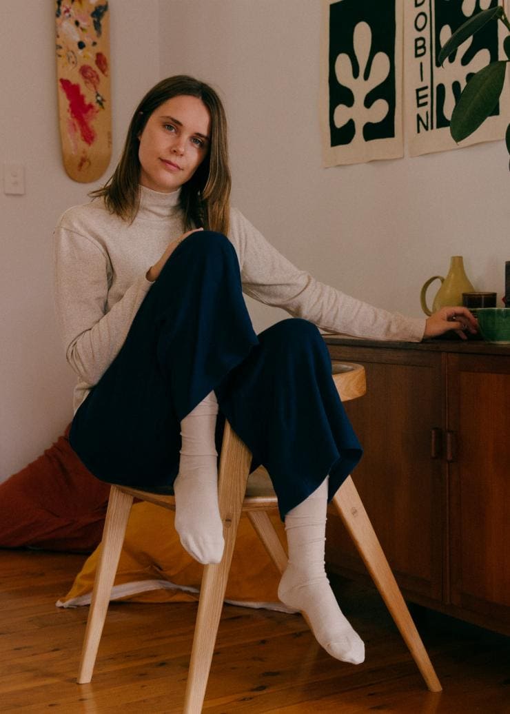A person relaxing on a stool wearing chic, comfortable clothing in a stylish home, Vege Threads, Melbourne, Victoria © Tané Meiring 