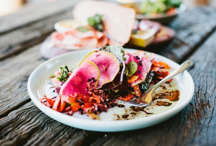 Close-up view of a colourful plated dish at Three Blue Ducks, Byron Bay, New South Wales © Destination NSW