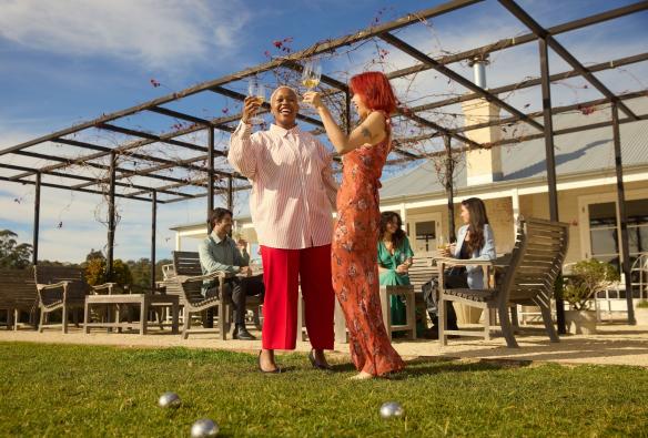 Friends playing a round of lawn bowls while enjoying a glass of wine at Mount Pleasant Wines, Pokolbin, New South Wales © Destination NSW 
