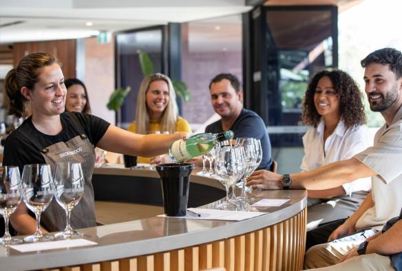 A group enjoys sampling a number of wines at Brokenwood Wines, Hunter Valley, New South Wales © Tourism Australia
