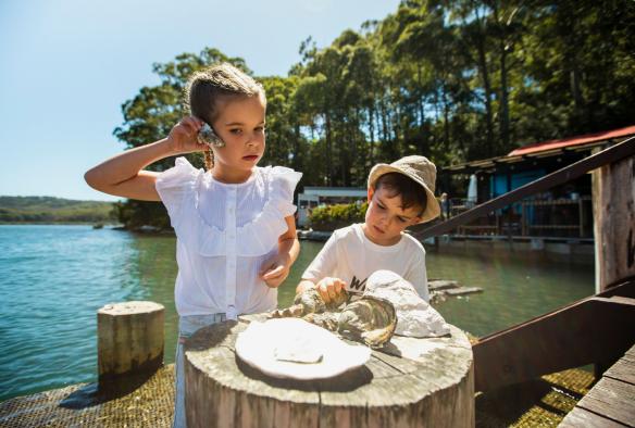 Family enjoying a visit to the Oyster Shed on Wray Street in Batemans Bay, New South Wales © Destination NSW