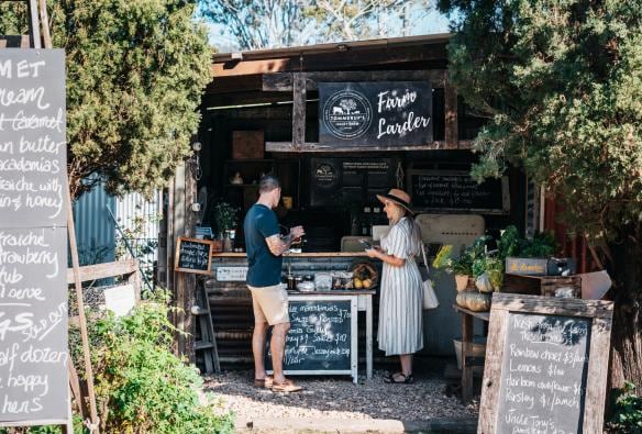 Couple tasting cheeses at a market stall at Tommerups Dairy Farm, Kerry, Queensland © Tourism and Events Queensland 