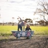 A young boy and girl play in an outdoor bathtub painted with flowers at Redwing Farm, Yorke Peninsula, South Australia © Tourism Australia 