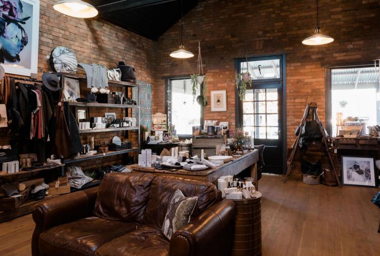 The interior of a cosy store with wooden floors and rustic brick walls, Seventh Pocket, Yackandandah, Victoria © Georgie James