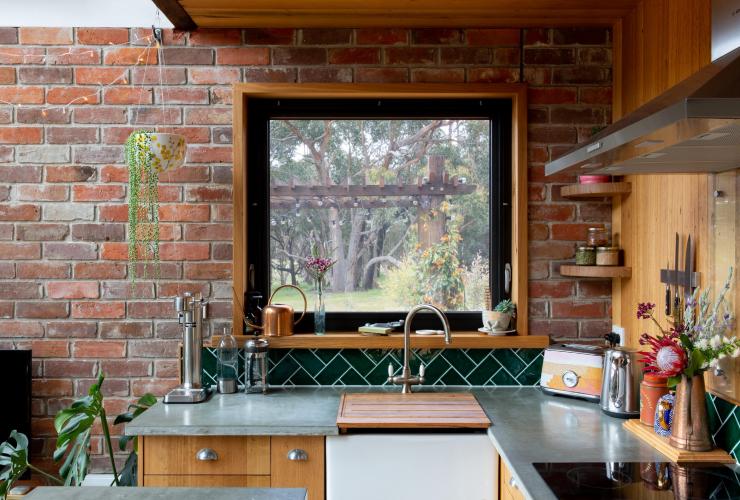 A kitchen with a window overlooking bushland, Nook on the Hill, Grampians, Victoria © Visit Victoria