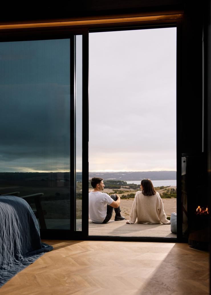A couple seated on a balcony overlooking a coastline, Cabn, Kangaroo Island, South Australia © South Australian Tourism Commission