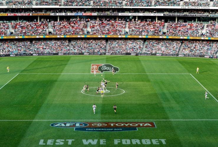 People playing AFL on a green field with a crowd watching from the stadium at Adelaide Oval, Adelaide, South Australia © Port Adelaide Football Club