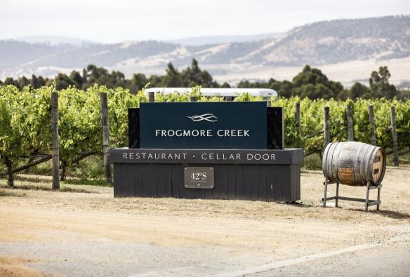 A winery sign in front of grapevines, Frogmore Creek, Cambridge, Tasmania © Tourism Australia