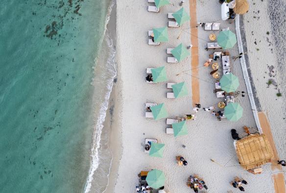 An aerial view shows a food and wine festival set up on a beautiful, white sandy beach at Pair’d Margaret River, Australia’s South West, Western Australia © Tourism Australia